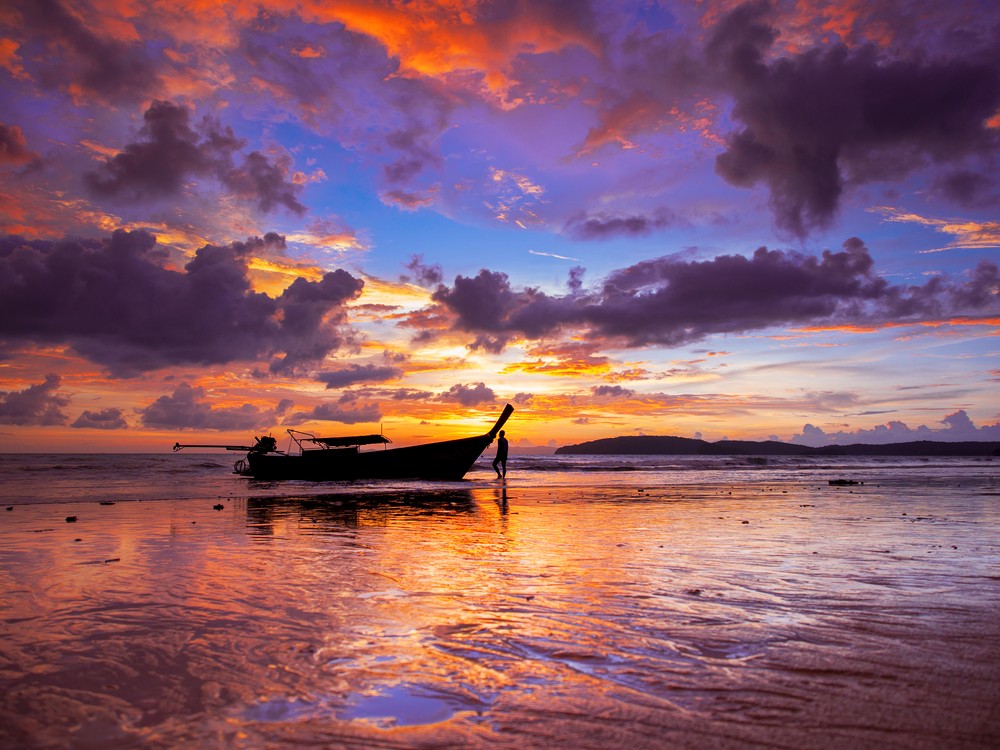 A stunning sunset view over the Andaman Sea with long-tail boats, located near a hotel in Ao Nang, Krabi. A stunning sunset view over the Andaman Sea with long-tail boats, located near a hotel in Ao Nang, Krabi.